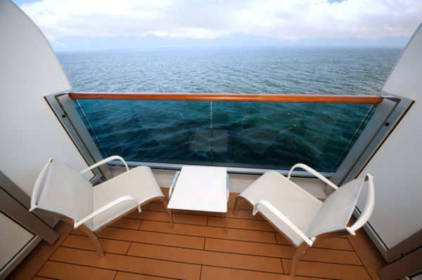 balcony with chairs table with view on sea on ship